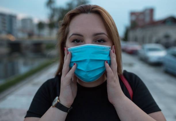 istock Blonde woman wearing protective mask 1276184678