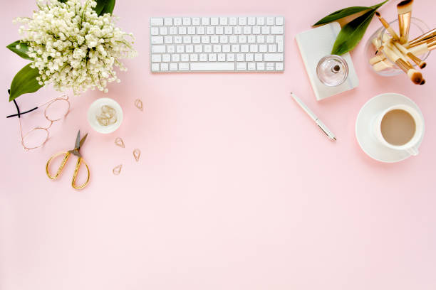 istock Office table desk with computer, lilac, clipboard. magazines. Top view Flat lay. Home office workspace. Women's fashion accessories on pink background 1276188867