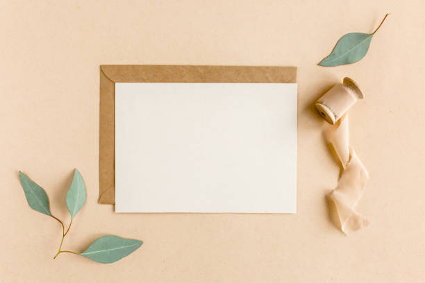 istock Mockup invitation, blank greeting card and craft envelope, green leaves eucalyptus. Flat lay, top view 1276212598