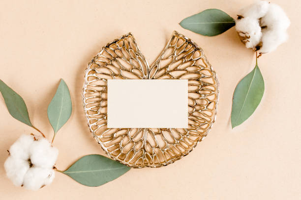 Mockup invitation, blank greeting card and green leaves eucalyptus. Flat lay, top view