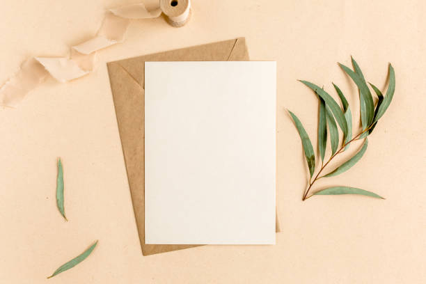 istock Mockup invitation, blank greeting card and craft envelope, green leaves eucalyptus. Flat lay, top view 1276219562
