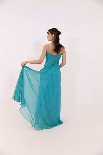 Rear view of young women in elegant turquoise blue dress