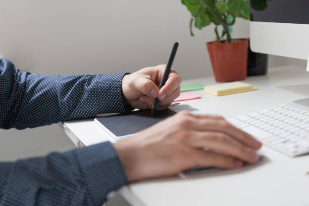 istock Detail of designer working with a digital tablet at his office 1276243883