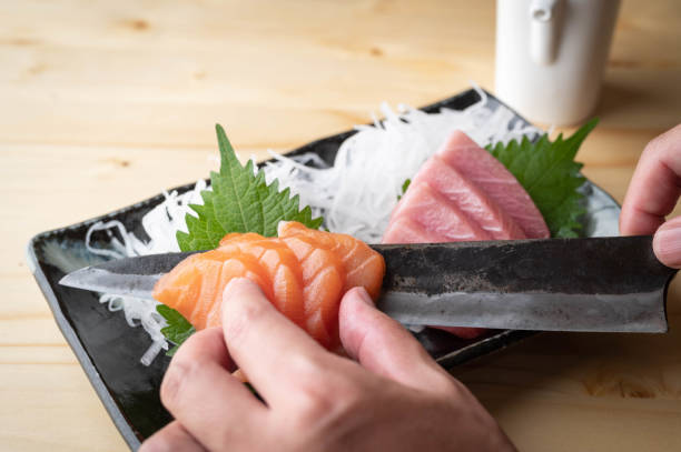 istock chef garnishing sashimi with japanese knife 1276257659