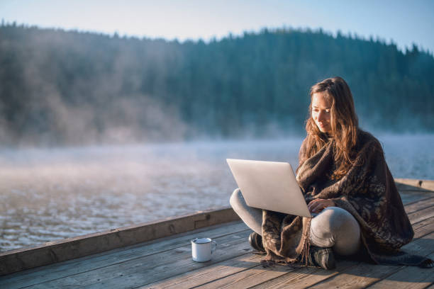 istock Woman Using Laptop In Nature. 1276258720