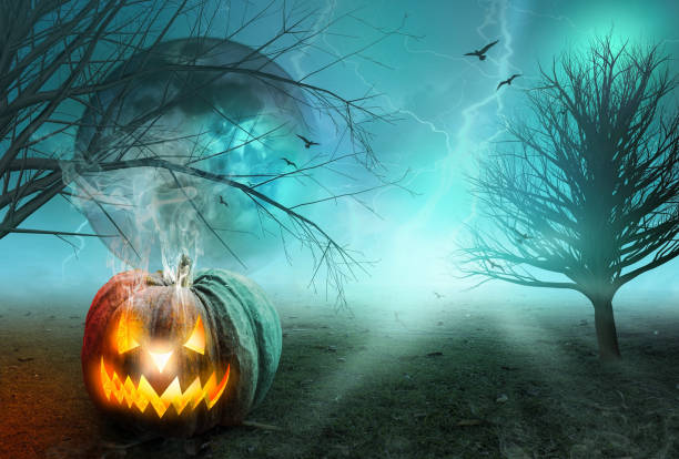 istock Halloween concept: Spooky pumpkin with moon and dark forest 1276328744
