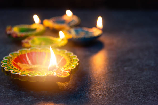 istock clay lit light a fire already on Diya or oil lamp 1276349524
