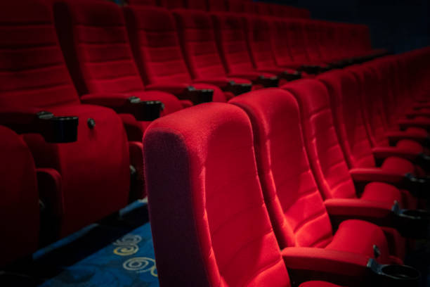 istock Empty comfortable red seats with numbers in cinema 1276351046