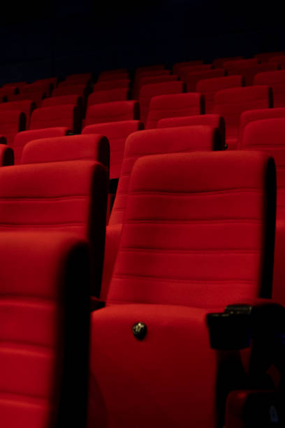 istock Empty comfortable red seats with numbers in cinema 1276351145