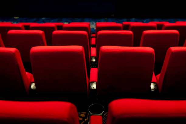 istock Empty comfortable red seats with numbers in cinema 1276351158