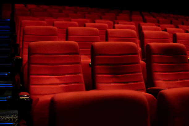 istock Empty comfortable red seats with numbers in cinema 1276351224