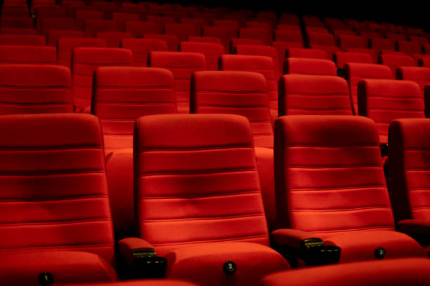istock Empty comfortable red seats with numbers in cinema 1276351226