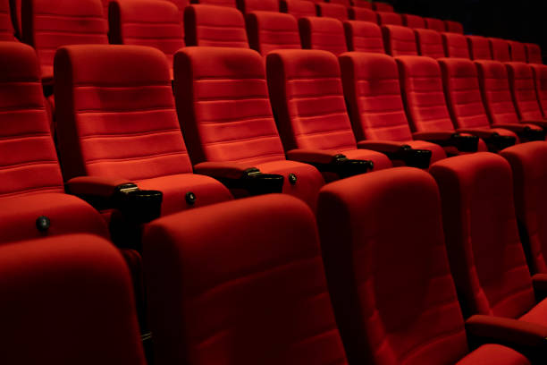 istock Empty comfortable red seats with numbers in cinema 1276351239