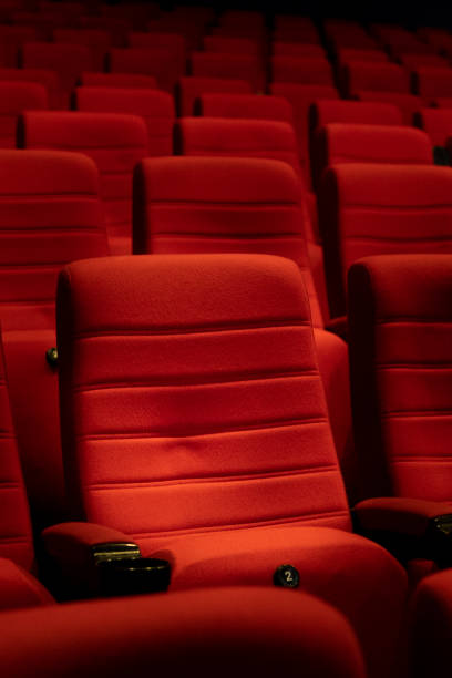 istock Empty comfortable red seats with numbers in cinema 1276351766