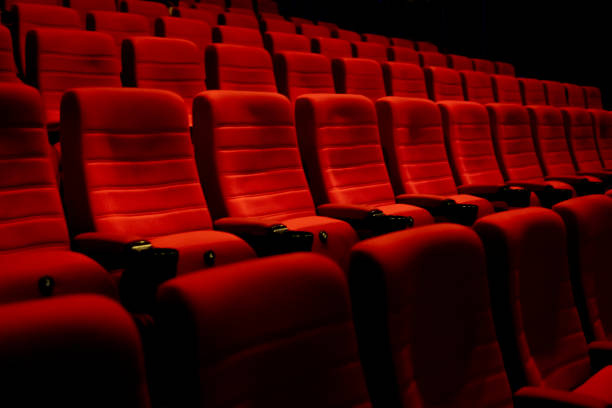 istock Empty comfortable red seats with numbers in cinema 1276351790