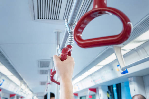 istock Young male passenger's hand holding the handle on the subway 1276351844