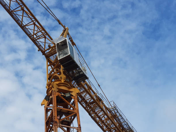 istock Stock Tower Crane at Yard The Tower Crane is lifting things at the construction site with a hook in front. 1276351852