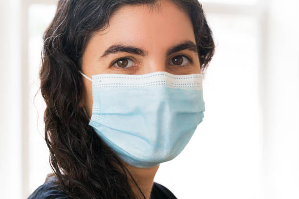 istock Young woman wearing face mask 1276356810
