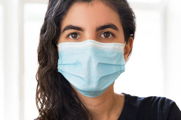 istock Young woman wearing face mask 1276356889