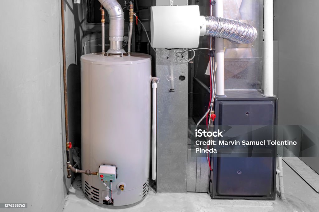 A home high efficiency furnace with a residential gas water heater & humidifier. Furnace Stock Photo