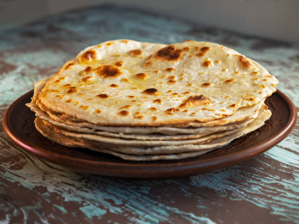 istock Taco cakes lay in a stack on a brown plate on a variegated wooden background 1276363016