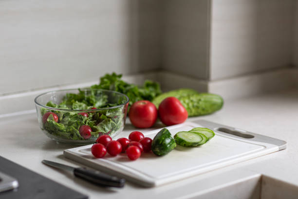 istock Healthy vegetarian dish on table, vegetable salad with fresh tomato, cucumber, lettuce. Diet menu 1276367409