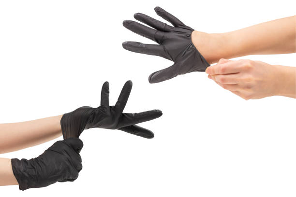 istock Woman puts on black rubber gloves. 1276367431