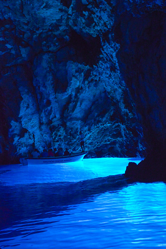The Blue Grotto or Blue Cave, is a waterlogged sea cave located in a small bay called Balun, on the east side of the island of Biševo and about 4.5 nautical miles (8.3 km) from Komiža, in the Croatian Adriatic. It is situated in the central Dalmatian archipelago, 5 km south-west of the island of Vis. The grotto is one of the best known natural beauty spots on the Adriatic and a popular show cave because of the glowing blue light that appears at certain times of day.