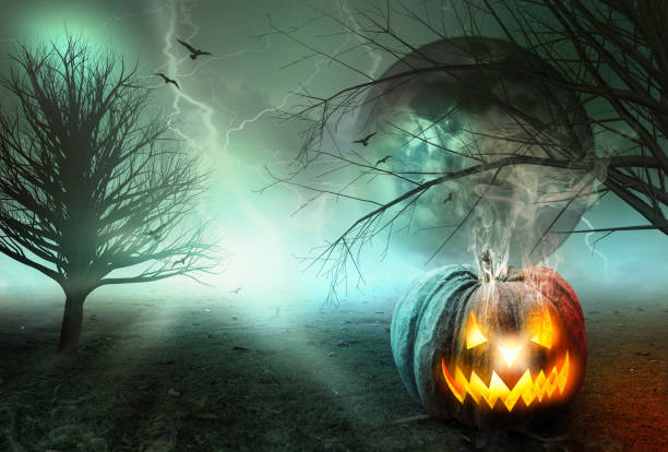istock Halloween concept: Spooky pumpkin with moon and dark forest 1276369209