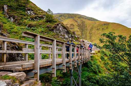 Ben Nevis / UK - August 24 2019: The track up Ben Nevis commonly referred to as the 'Tourist Route,' the 'Tourist Track' or the 'Pony Track' is in fact the old access route to the now ruined Observatory and was designed as a rough bridle path for ponies. It is the easiest way to get on the top of the highest mountain in Britain.