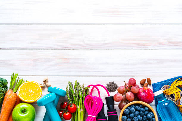 sports and healthy food border: fruits, vegetables, nuts, dumbbels and tape measure. copy space - superfood food healthy eating healthy lifestyle imagens e fotografias de stock