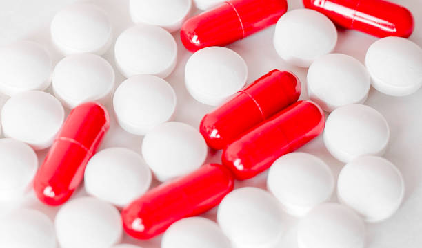 istock Image of red and white pills on white background. Medicine concept, 1276373690