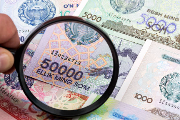 istock Uzbekistani money in a magnifying glass 1276374784