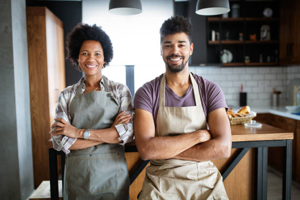 istock Beautiful young couple having fun and laughing while cooking in kitchen 1276375717
