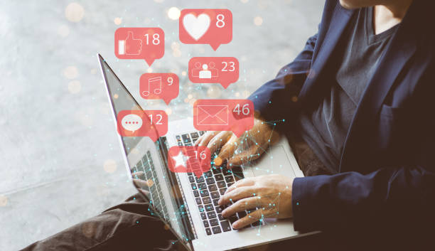 istock Businessman using laptop with social media icon 1276376056