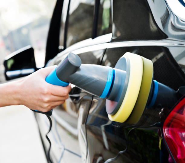 istock Woman hand using hand held car polishing machine 1276376775