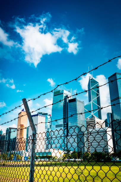 istock Cityscape outside barbed wire fence 1276379533