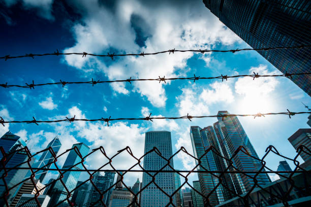 istock Cityscape outside barbed wire fence 1276380196