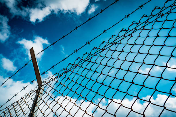 Cityscape outside barbed wire fence