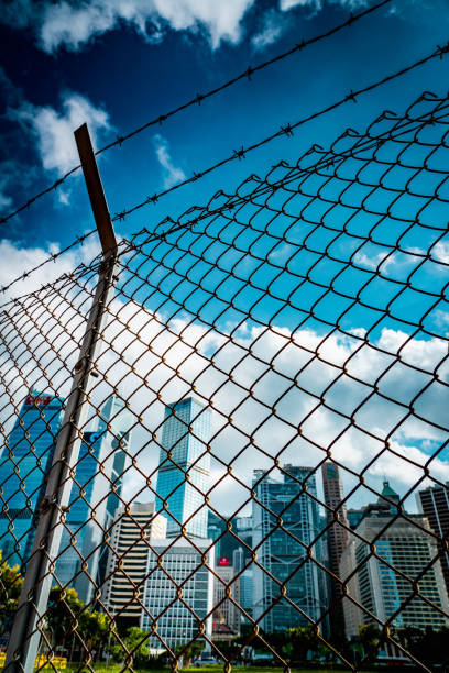 istock Cityscape outside barbed wire fence 1276380843