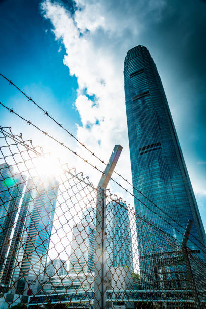 istock Cityscape outside barbed wire fence 1276380938