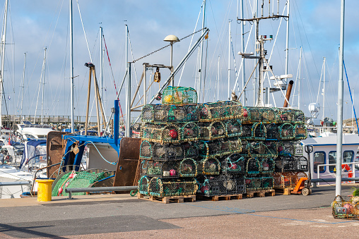 Lobster traps in front of fishing boat. Island of Vrango in Gothenburg archipelago.