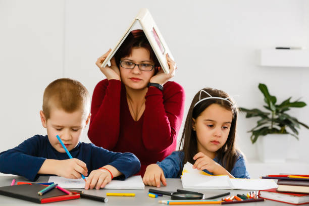 istock children and a tired teacher in classroom 1276385545