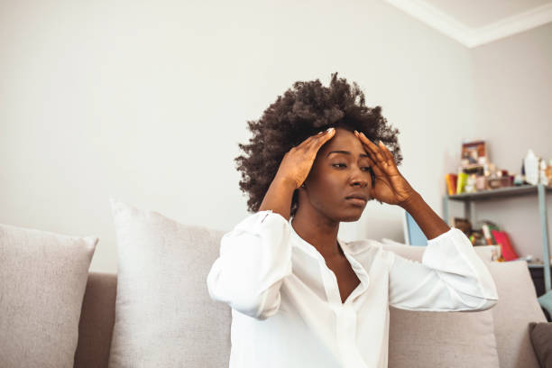 istock Woman suffering from stress or a headache grimacing in pain 1276385848