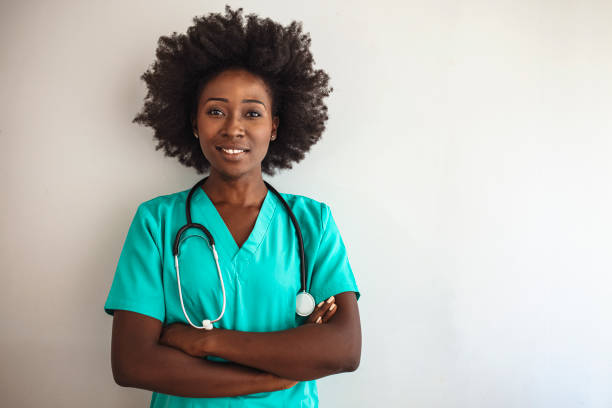 istock Friendly nurse with stethoscope isolated on grey. 1276386739