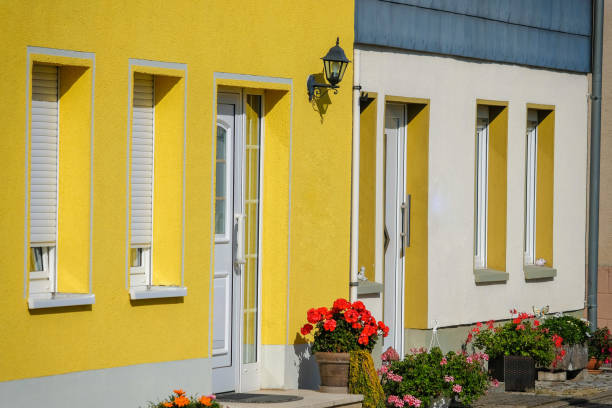 istock yellow house with flowers and windows 1276386792