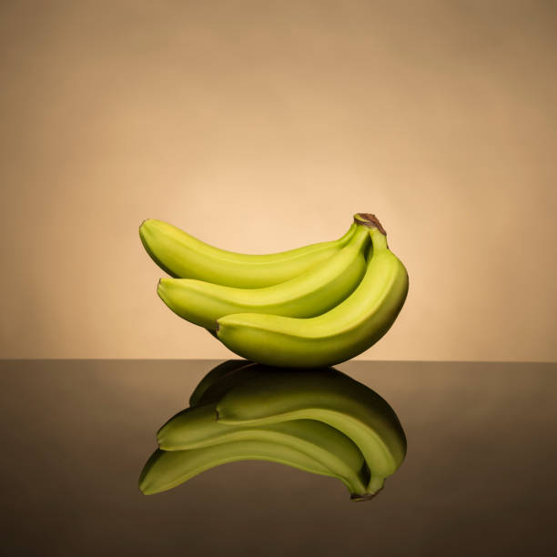istock Bananas and their reflection on a colorful background 1276392837