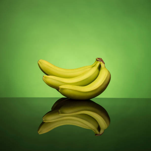 istock Bananas and their reflection on a colorful background 1276393052