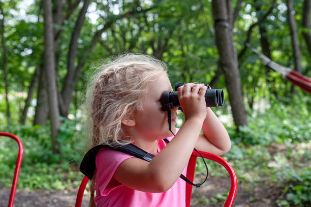 istock Girl Holding Plant Against Trees 1276393639