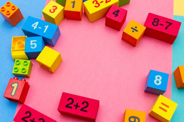 istock child kid colorful education toys cubes with numbers math pattern background on the bright background. Flat lay. Childhood infancy children babies concept. 1276396467